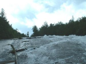 <b>Bridal Veil Falls</b><br> Just to the left of the log is the area where the young man lost his footing attempting to walk up the slick rock face.