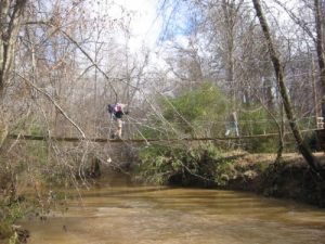 <b>Steele Creek Suspension Bridge</b><br> Here we are crossing the suspension bridge over Steele Creek. This is one of a number of these type of bridges in the Anne Springs Close Greenway.