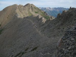 <b>The Saddle Near the Summit</b><br> With a great view from the saddle, many people stop there. The trail across the shale is steep, narrow, and treacherous in places.