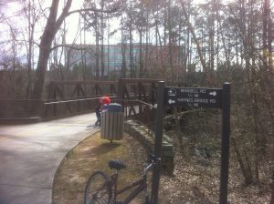 <b>The Paved Walking/Bike Trail</b><br> One of the numerous bridges along the paved portion of this walking/bike trail with a corporate business seen through the trees in the distance.